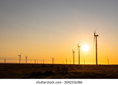 General view of wind turbines in countryside landscape during sunset. environment, sustainability, ecology, renewable energy, global warming and climate change awareness. - Powered by Shutterstock
