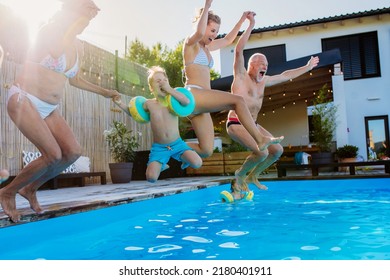 Generation family having fun together when jumping into the swimming pool at backyard. - Powered by Shutterstock