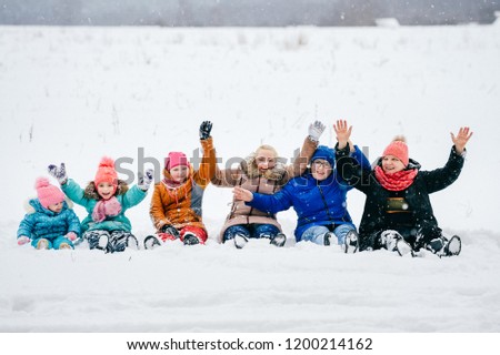 Generation Female - Grandmother, Mothers, Daughters, Granddaughters. Relatives all together sitting happy in snow at field. Big loving funny family at winter picnic have fun. Adults and children joy