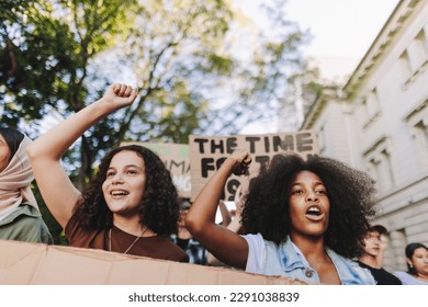 Generation Z taking action against climate change. Group of youth activists protesting against global warming and pollution. Multicultural young people joining the global climate strike. - Powered by Shutterstock