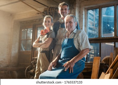 Generations Of Carpenters In Their Family Business Workshop Looking At The Camera