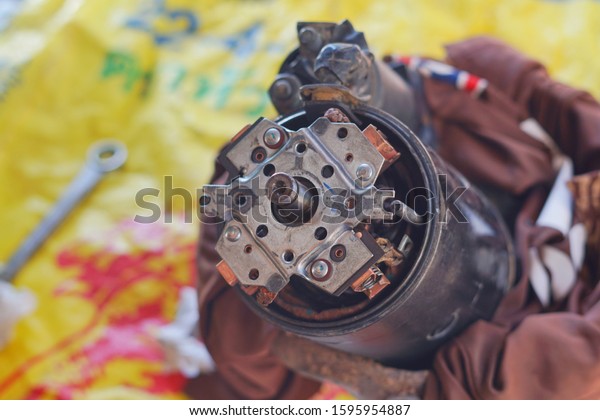 Generator set or genset dynamo
starter motor engine Inside for repair copper coil and maintenance
spring, Ball bearing and insert Grease for Rust prevention, close
up.