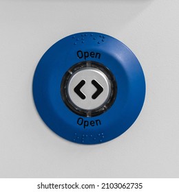 Generic blue and grey 'OPEN' button, usually seen on train doors, shot straight on.