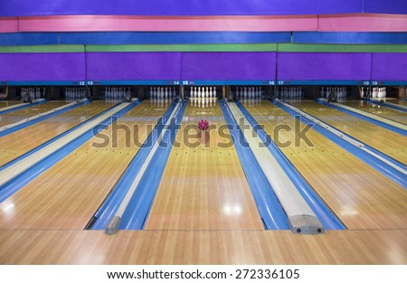 Generic Bowling Alley lanes with bowling ball going towards the pins