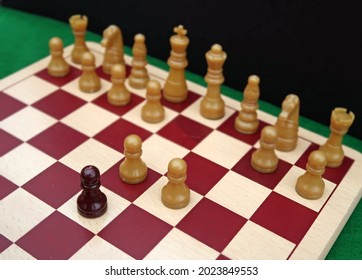 Generic Chess Pieces With Pawns Set Up On Wooden Board To Show The Initial Moves Of A Classic Game Opening Called The Queens Gambit. Metaphor For Intelligence Strategy, Planning And Tactics