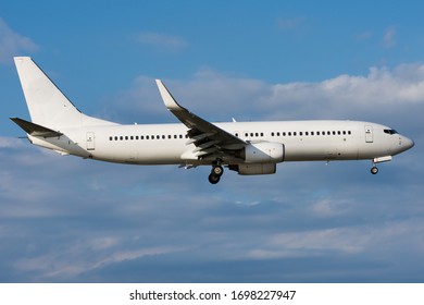 Generic Commercial Aircraft With Clouds In Background.