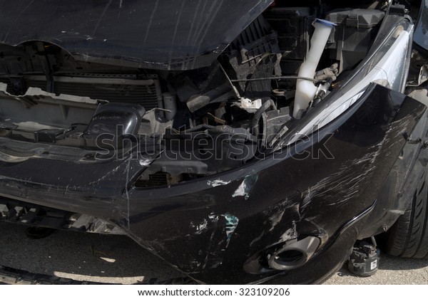Generic compact car damaged in a\
rollover accident. Car crash wreck - insurance\
concept