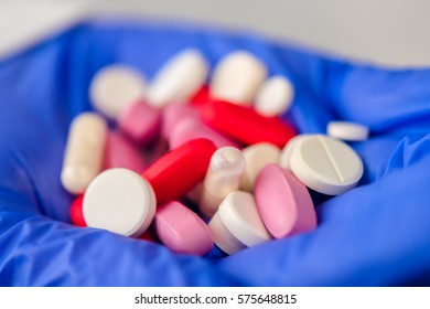 Generic Drugs, Female Doctor With Hand Full Of Various Pills And Medications, Close Up Of Medical Professional In White Coat And Protective Gloves