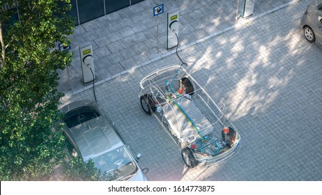 generic electric car with battery visible x-ray charging at public charger in city parking lot 3d render - Shutterstock ID 1614773875