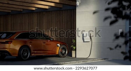 Generic electric vehicle EV hybrid car is being charged from a wallbox on a contemporary modern residential building house