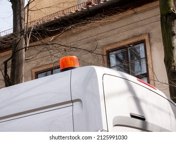 Generic emergency service vehicle van with an orange emergency light on top, flashing beacon siren signal on a car roof, object closeup, detail, nobody. Urban construction, cleaning services concept - Shutterstock ID 2125991030