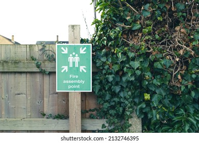 Generic Fire Safety Sign Seen Erected On A Wooden Fence, Which Is Adjacent To A Residential Care Home.