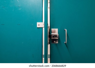 Generic Metal Public Bathroom Stall Latch Closed With The Door Gap Shown. 