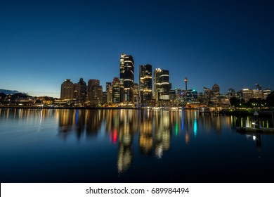 Generic Modern Cityscape With Water Reflection In Night, Harbour City With Skyscraper Skyline
