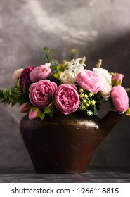 Generic Peonies In A Clay Pot On A Gray Table. Free Space For Text. Holiday Postcard. Floral Background.