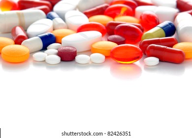 Generic Prescription Medicine Drugs Pills And Assorted Pharmaceutical Tablets With Gel Caps Of Assorted Colors And Shapes Over White