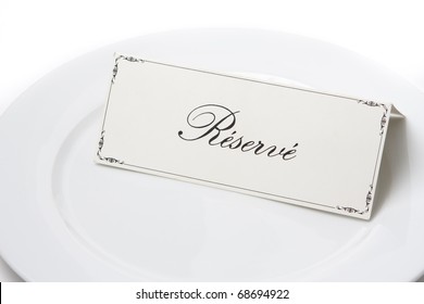 Generic Reserved Sign Card On A White Plate