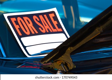 Generic For Sale Sign Mounted On The Windshield Of A Used Car.