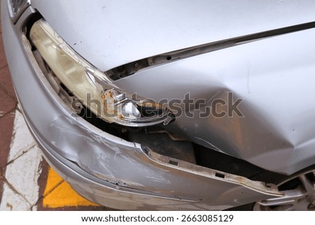 Generic silver car with damaged front bumper and broken headlamp. Minor accident result - fender bender in Malaysia.