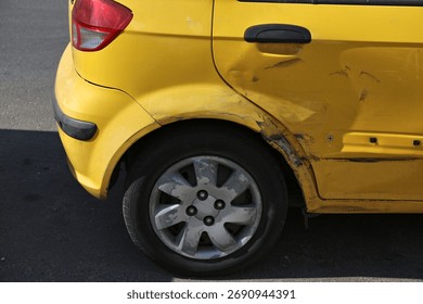 Generic small hatchback car with dented rear passenger door. Minor accident result - fender bender.