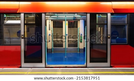 Generic underground train in London. Empty carriage with open doors standing at the platform. Used by millions of tourists and commuters annually.
