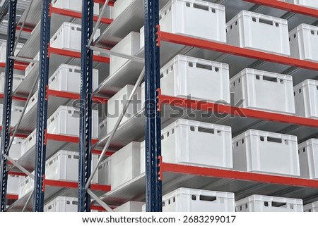 Generic white unlabeled boxes and crates on shelves of a warehouse rack, abstract industrial background