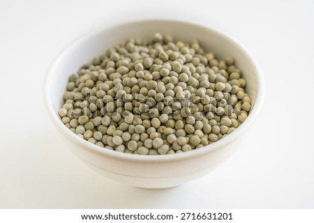 A generous heap of whole dried green peas or marrowfat peas, used in various cuisines.