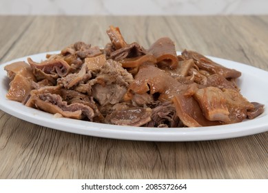 Generous Portion Of Carnitas Pork Meat On A Plate Mixed With Roasted Peppers For A Full Flavor Meal.