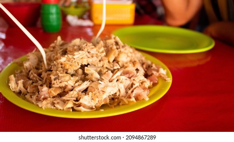 Generous Portion Of Carnitas Pork Meat On A Plate Mixed With Roasted Peppers For A Full Flavor Meal.