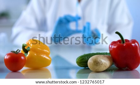 Genetic breeding of vegetables in lab, biology scientist analyzing food quality
