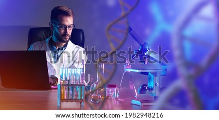 A geneticist in the laboratory. A man is engaged in manipulating genes. Chemist working with sample tubes test in laboratory. DNA sequencing in laboratory. Geneticist deals with DNA sequencing. 