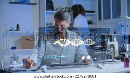 Genetics laboratory worker studying human genome structure on holographic screen