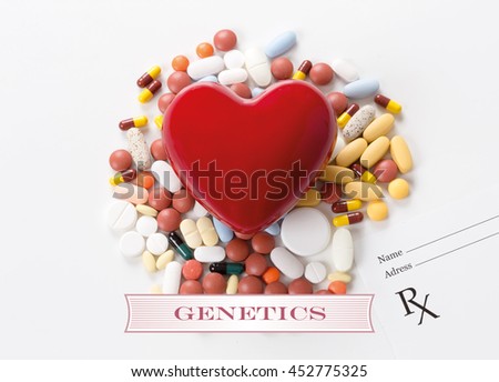 GENETICS written on heart and medication background