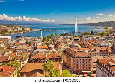 Geneva skyline cityscape, French-Swiss in Switzerland. Aerial view of Jet d'eau fountain, Lake Leman, bay and harbor from the bell tower of Saint-Pierre Cathedral. Sunny day blue sky.