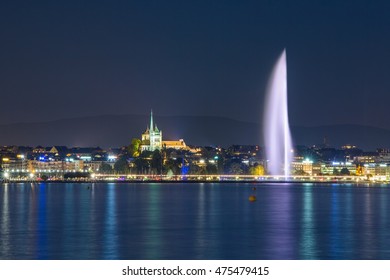 Geneva skyline and fountain at night.