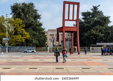 Geneva, Switzerland - April 15, 2019:  Broken Chair Monument Near United Nations Palace With Tourists - Image