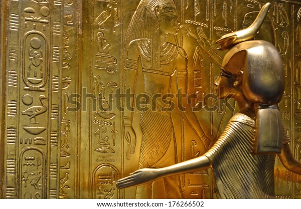 GENEVA, SWITZERLAND - DECEMBER 17: Ancient egyptian gold statue of the protecting goddess Serket at the Tutankhamun exhibition :  December 17, 2013 in Geneva Switzerland