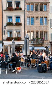 Geneva, Switzerland, Europe - 09.28.2012 : People Eating Outside, Place Du Bourg-de-Four, Famous Square And Meeting Point In Historic Part Of The City