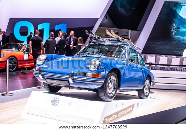 Geneva, Switzerland, March\
05, 2019: vintage blue Porsche 911 2.0 Coupe 1965 glossy and shiny\
old classic retro car at Geneva International Motor Show, Porsche\
Museum,