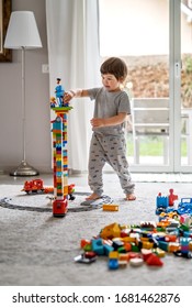 GENEVA, SWITZERLAND - MARCH 23, 2020: Little toddler boy playing with Lego blocks at home at quarantine isolation period during coronavirus pandemic. Child leisure activity, creative game