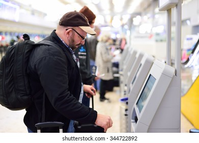 GENEVA, SWITZERLAND - NOVEMBER 19, 2015: passenger use self-registration kiosk in Geneva Airport. Geneva International Airport is the international airport of Geneva, Switzerland.
