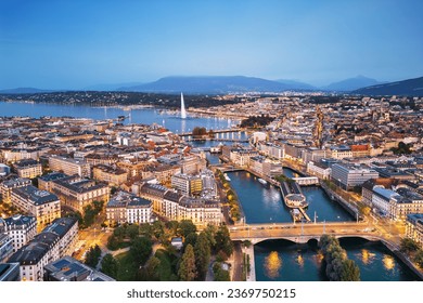 Geneva, Switzerland skyline view towards the Jet d'Eau fountain in Lake Geneva at twilight. - Powered by Shutterstock