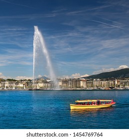 The Geneva Water Fountain, Jet d'Eau. One of the in Geneva so famous yellow boats. Lake Geneva, Switzerland.