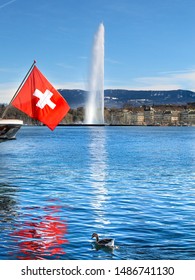 The Geneva Water Fountain, Jet d'Eau, in Geneva Switzerland. Lake Geneva. The swiss flag.