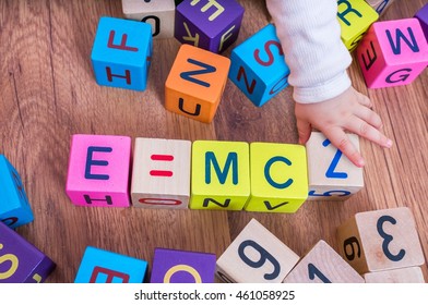 Genius Baby With High IQ Is Playing With Cubes And Writing Formulas.