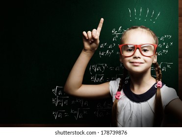 Genius Girl In Red Glasses Near Blackboard With Formulas