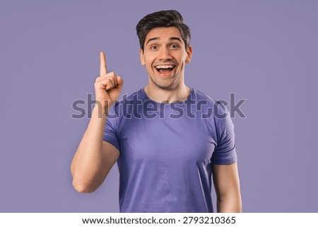 Genius man having idea eureka moment, pointing finger up on violet background. Clever student guy showing answer gesture or remembered what he forgot, memory concept. High quality