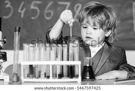 Similar – Image, Stock Photo Serious little boy playing with chemical liquids