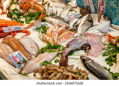 Genoa, Italy, 10/04/2019: A Variety Of Raw Fish On Ice On A Store Counter. Top View.