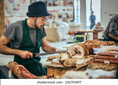 GENOA, ITALY - FEBRUARY 15, 2015: Unidentified Butcher Slicing Italian Pork Roast Porchetta At Food Market In Genoa, Italy